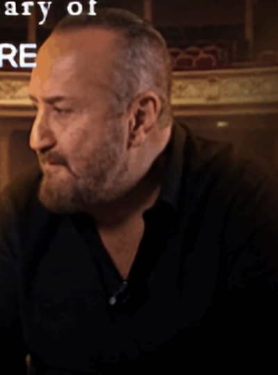 Ghassan Rahbani seated in the Theater, from the concert poster