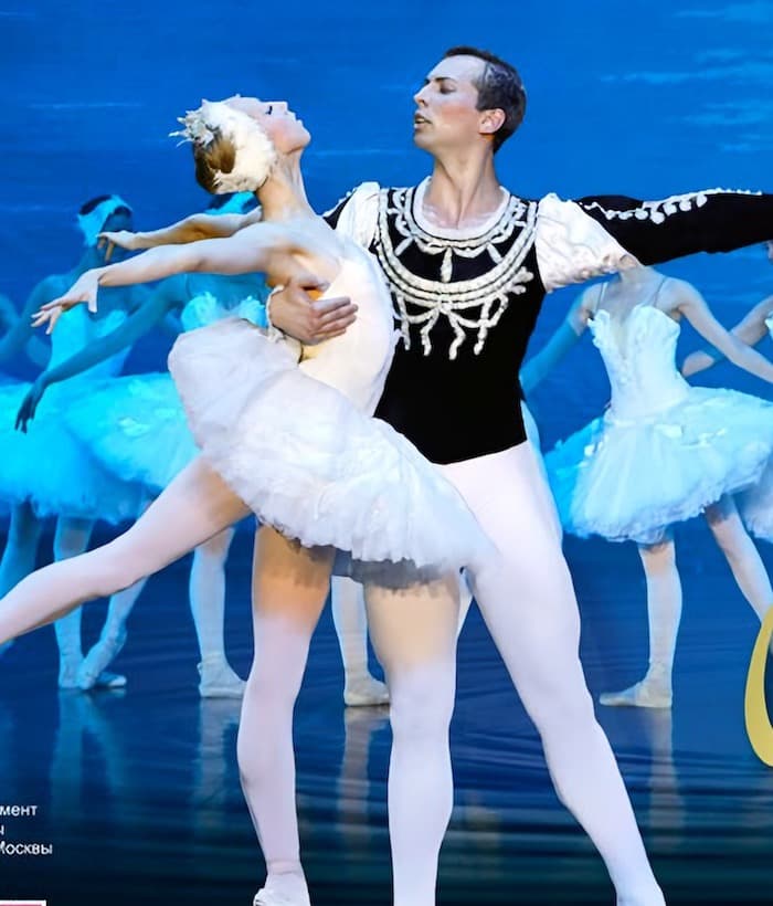The Swan Lake principal couple in front of the corps de ballet, from the company key art